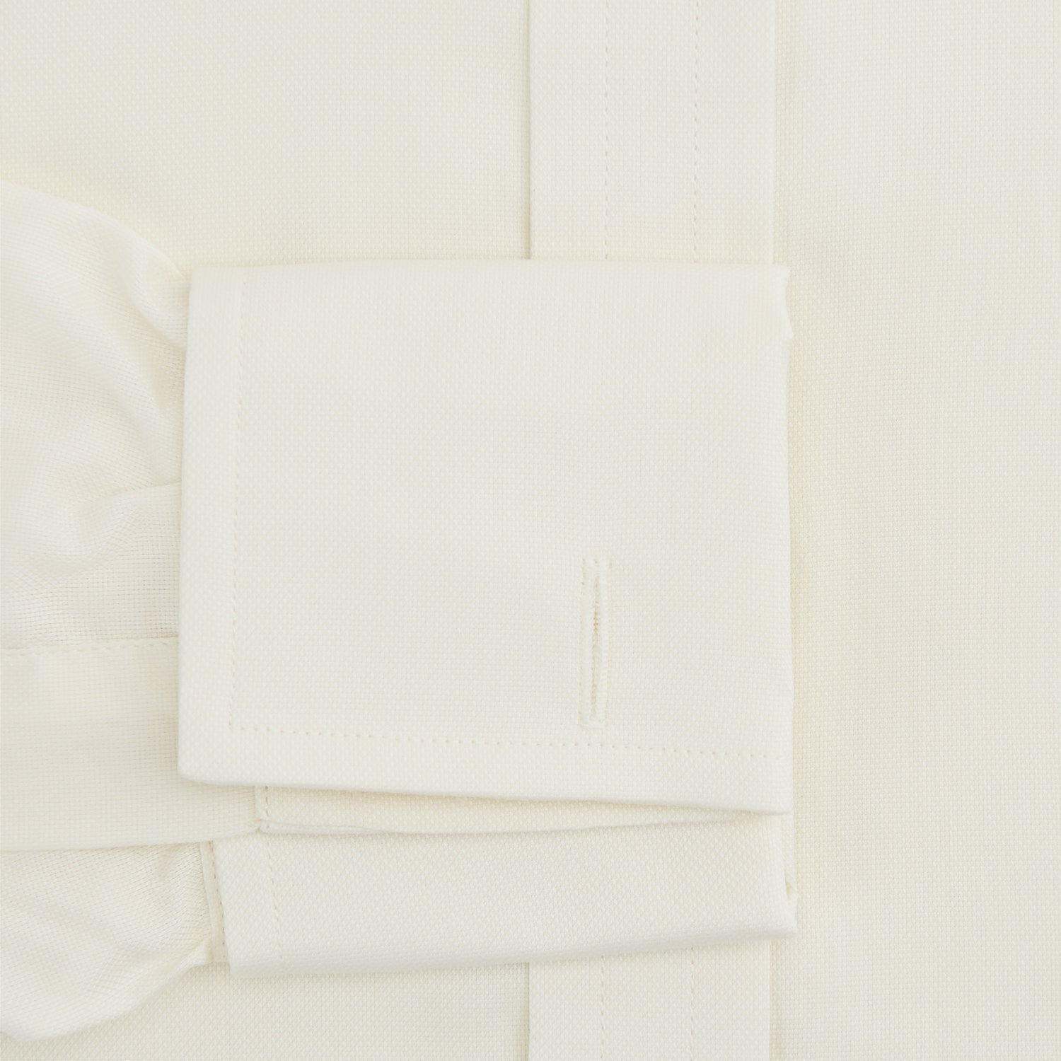 View 3 of product The Turnbull & Asser Tomorrow Never Dies Cream Cotton Hamburg Shirt, as seen on James Bond, features a long sleeve, button-down front, and collar. It's laid flat on a white background.