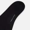View 3 of product The Turnbull & Asser Black Wool Long Sock stands upright on a white background, featuring a ribbed texture with a fitted foot and calf, ideal for those seeking stylish over the calf socks.