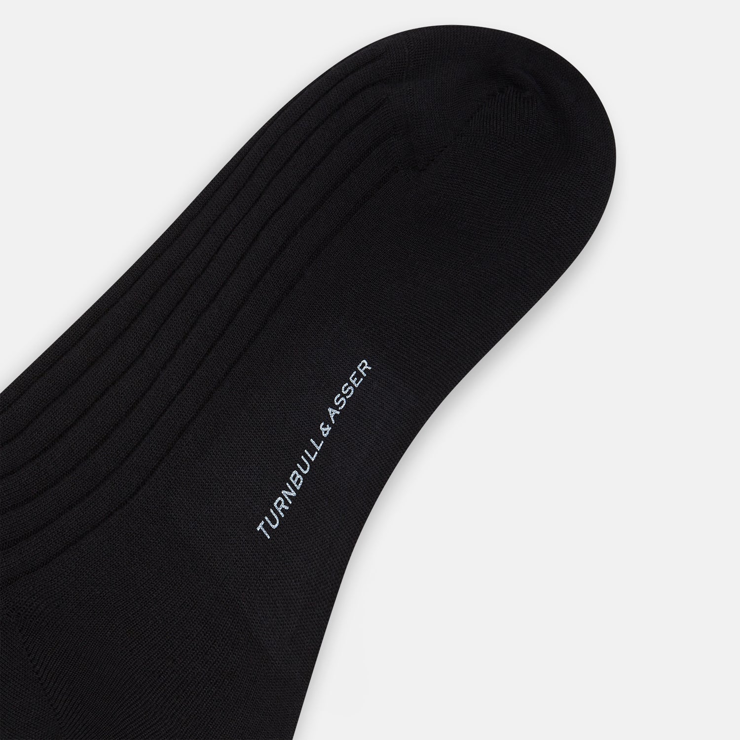 View 3 of product The Turnbull & Asser Black Wool Long Sock stands upright on a white background, featuring a ribbed texture with a fitted foot and calf, ideal for those seeking stylish over the calf socks.