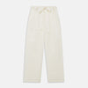 View 4 of product The Cream Pattern Cotton Blend Quin Pyjama Set by Turnbull & Asser features cream stripes, a long-sleeve button-up camp collar shirt with a chest pocket and black piping, and matching drawstring pants.