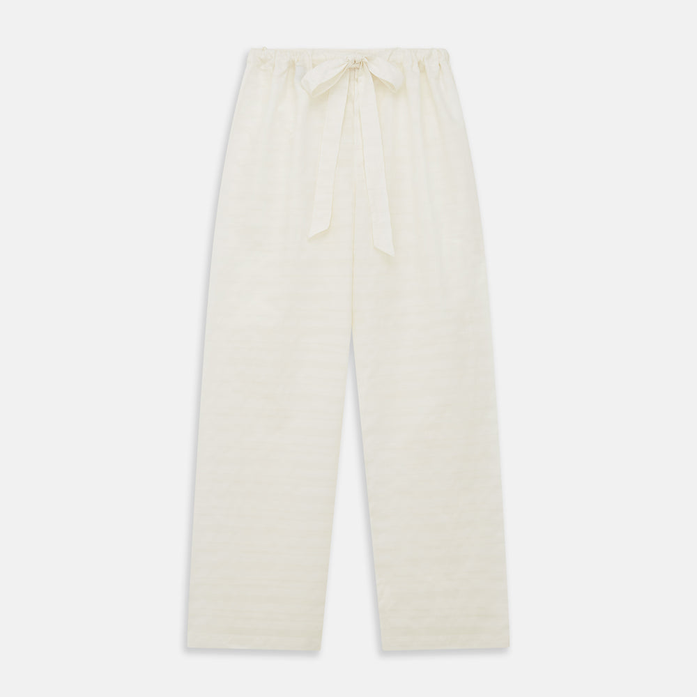 The Cream Pattern Cotton Blend Quin Pyjama Set by Turnbull & Asser features cream stripes, a long-sleeve button-up camp collar shirt with a chest pocket and black piping, and matching drawstring pants.