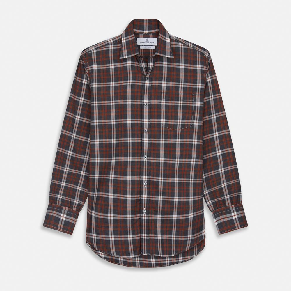 Close-up of Turnbull & Asser's Rust Check Cotton Fabric, featuring intersecting brown, black, and white stripes in a plaid pattern, displayed within a circular frame on a plain light gray background.