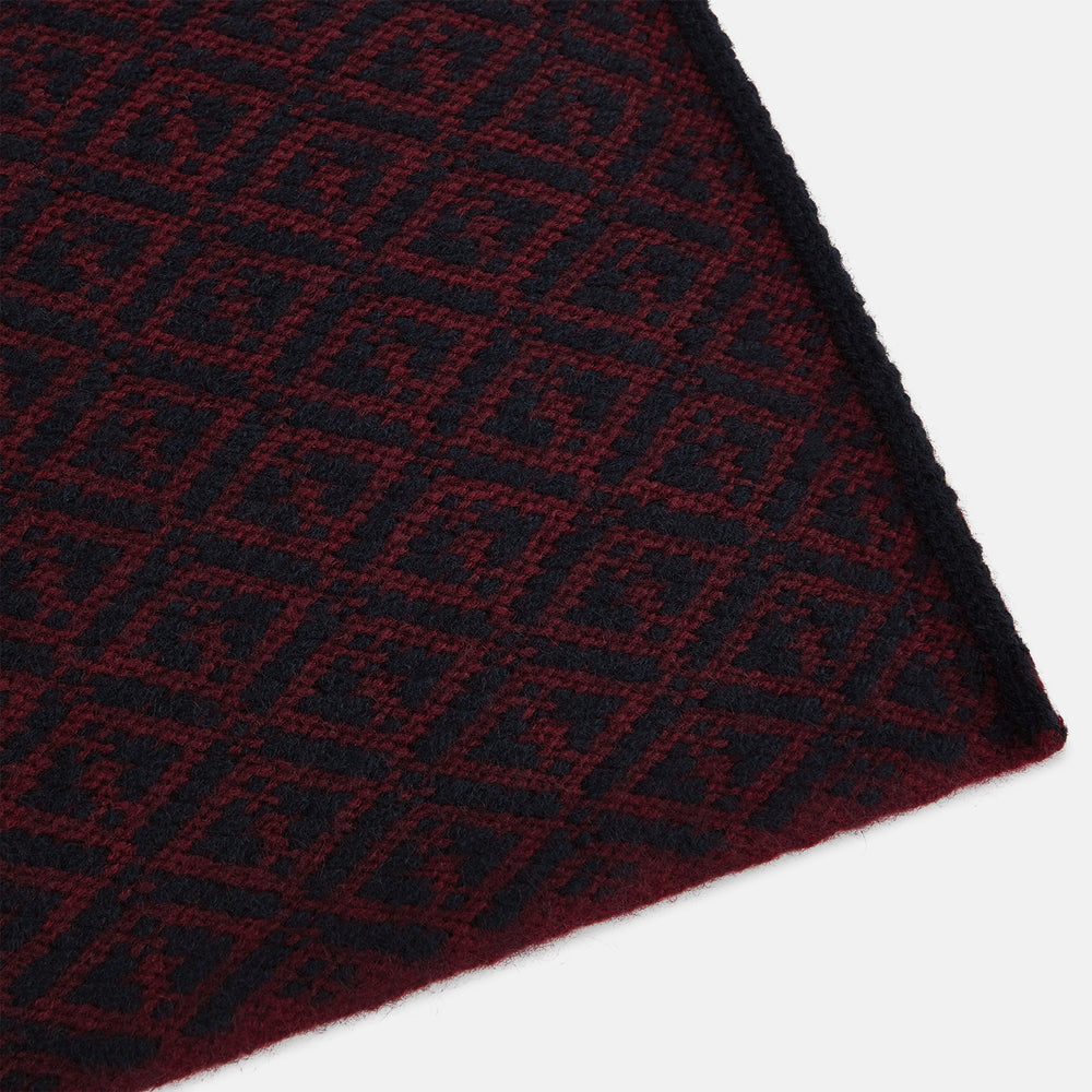 The Turnbull & Asser Navy and Burgundy Diamond-Patterned Cashmere Knitted Scarf, displayed upright on a plain white background, exudes sumptuous softness.