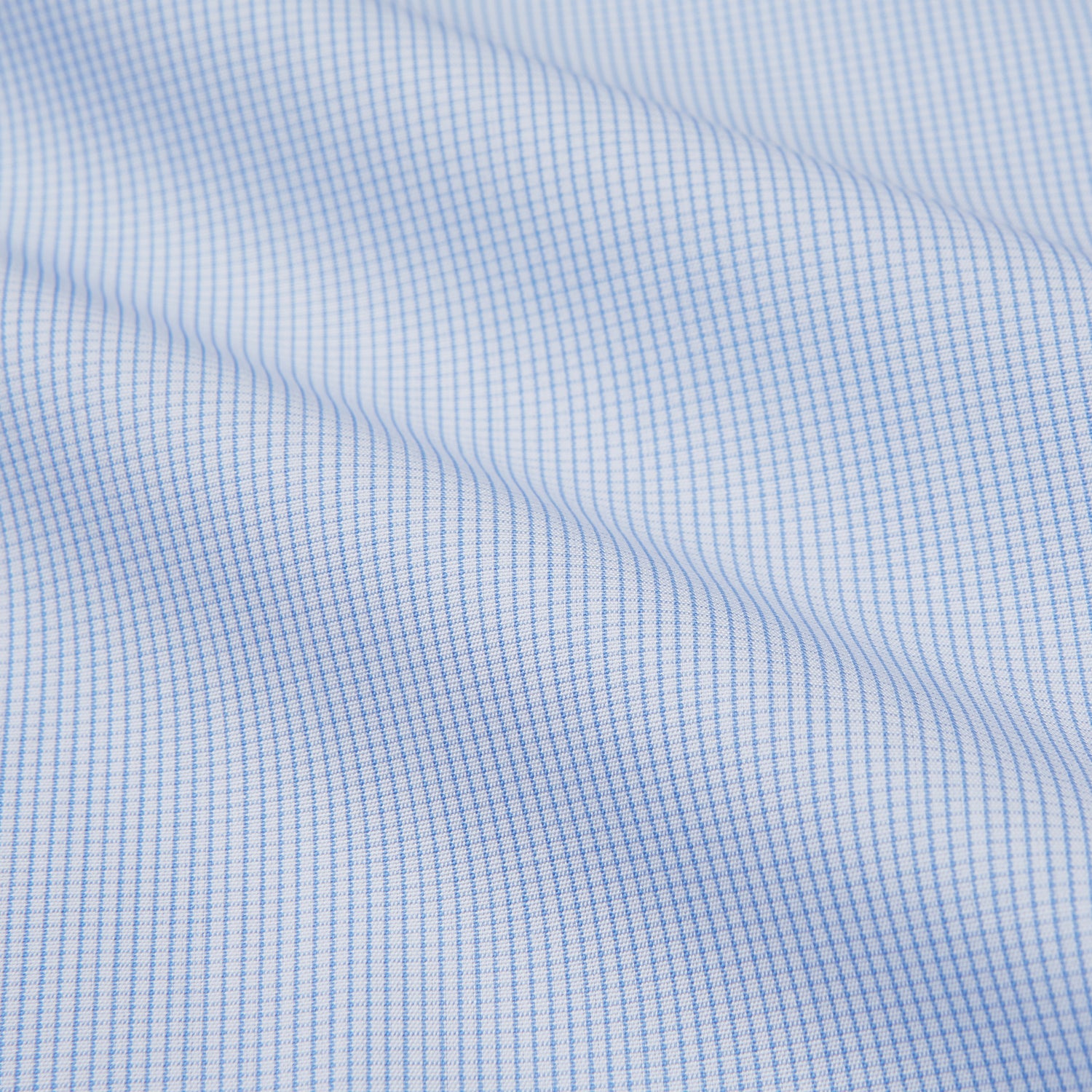 View 2 of product The Turnbull & Asser Micro Blue Check with White Collar and Cuff Shirt, a light blue long-sleeve style, features contrasting white collar and cuffs, buttoned down the front and laid flat on a white background.