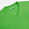 View 4 of product The Turnbull & Asser Lime Green Cashmere V-Neck Jumper features long sleeves and ribbed cuffs, hem, and neckline—ideal for adding vibrant color to your knitwear collection. Displayed on a white background.