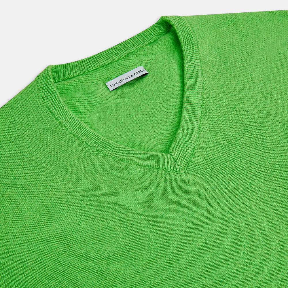 The Turnbull & Asser Lime Green Cashmere V-Neck Jumper features long sleeves and ribbed cuffs, hem, and neckline—ideal for adding vibrant color to your knitwear collection. Displayed on a white background.