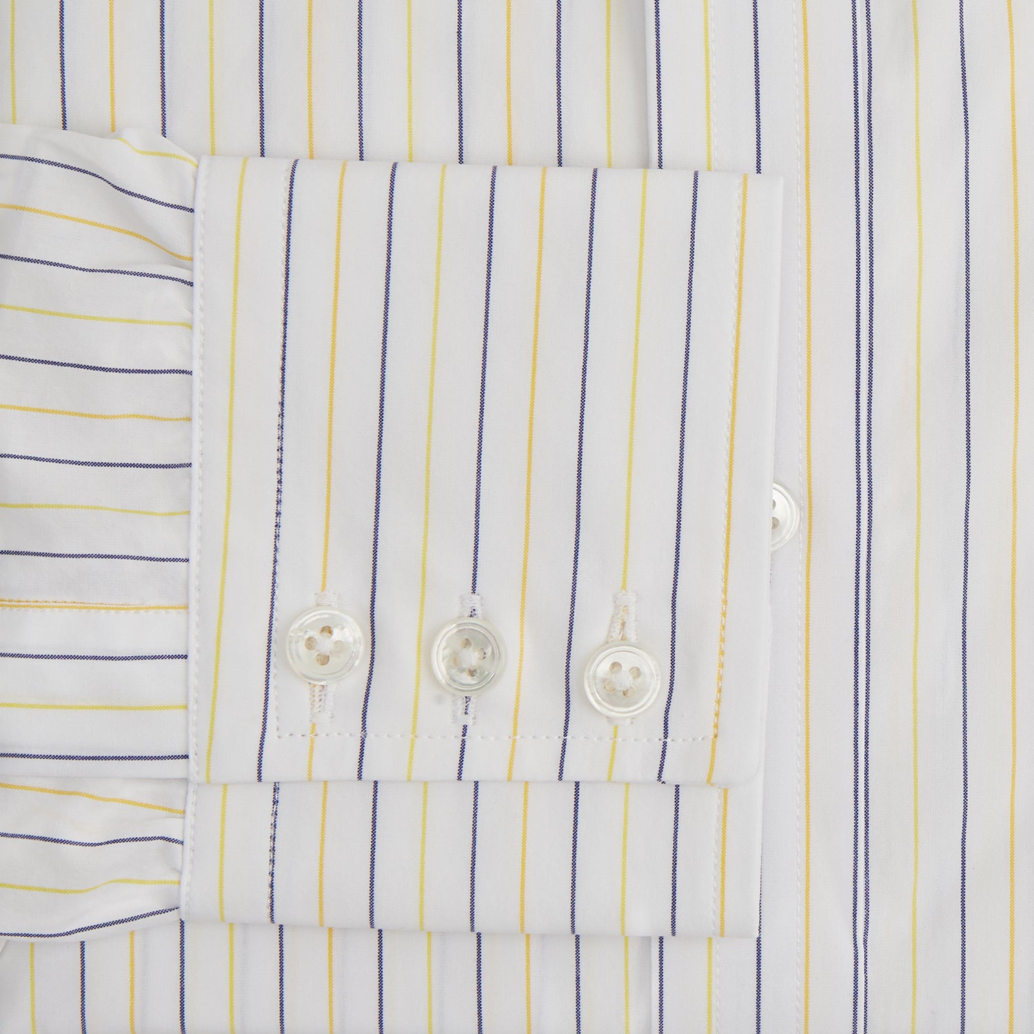 View 3 of product The Turnbull & Asser Yellow Double Pinstripe Mayfair Shirt, a long-sleeved, button-up with thin blue and yellow stripes on white, classic T&A collar, and buttoned cuffs, is laid flat on a white surface.