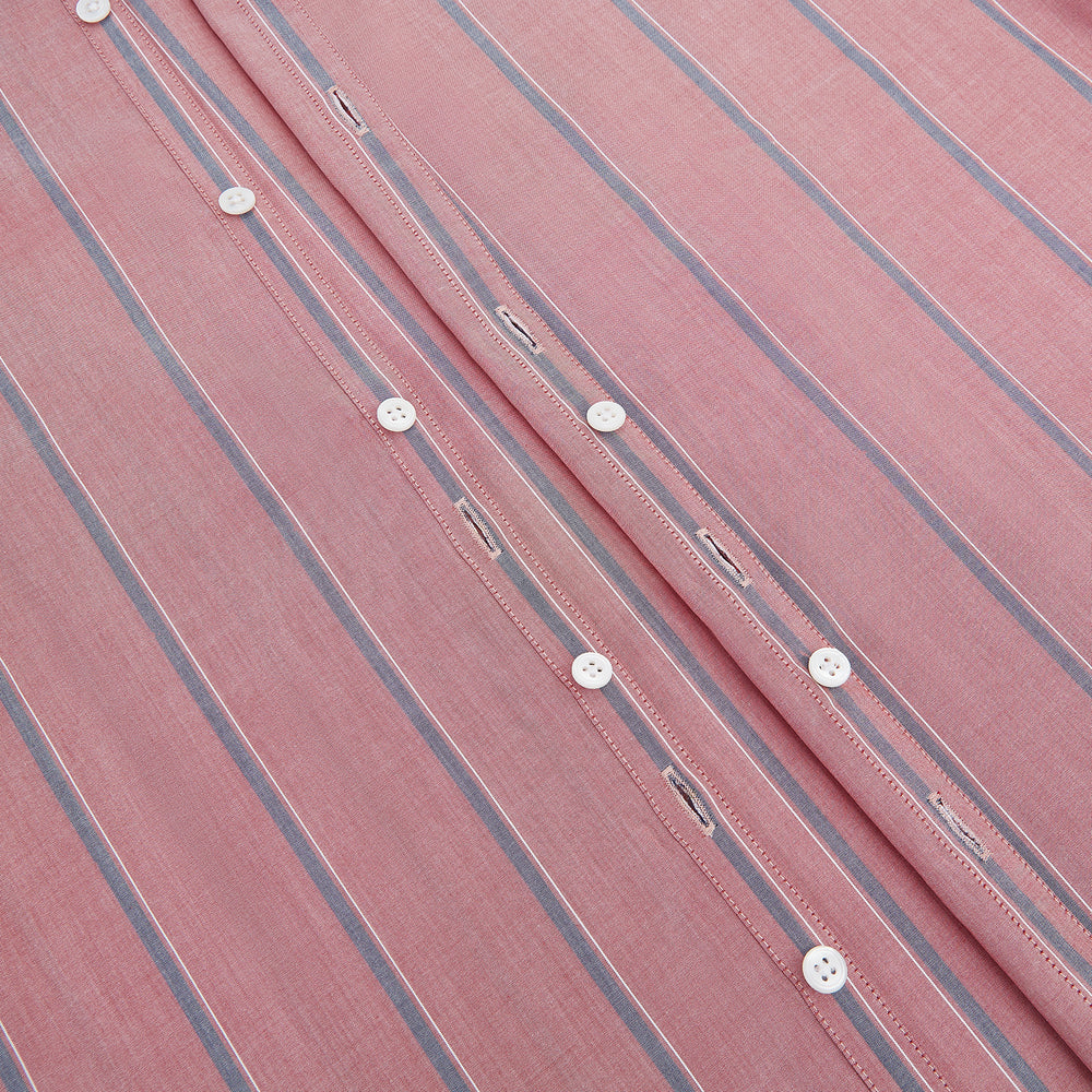 The Turnbull & Asser Red Track Stripe Westminster Shirt features British craftsmanship, a collar, pink base with vertical blue and white stripes, white buttons, and a pocket-free front for refined appeal.