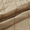 View 5 of product The Battersea Sand Quilted Jacket by Turnbull & Asser is a light beige men's jacket with a front zipper, pointed collar, zippered side pockets, chest pocket, and buttoned cuffs, shown on a plain white background.