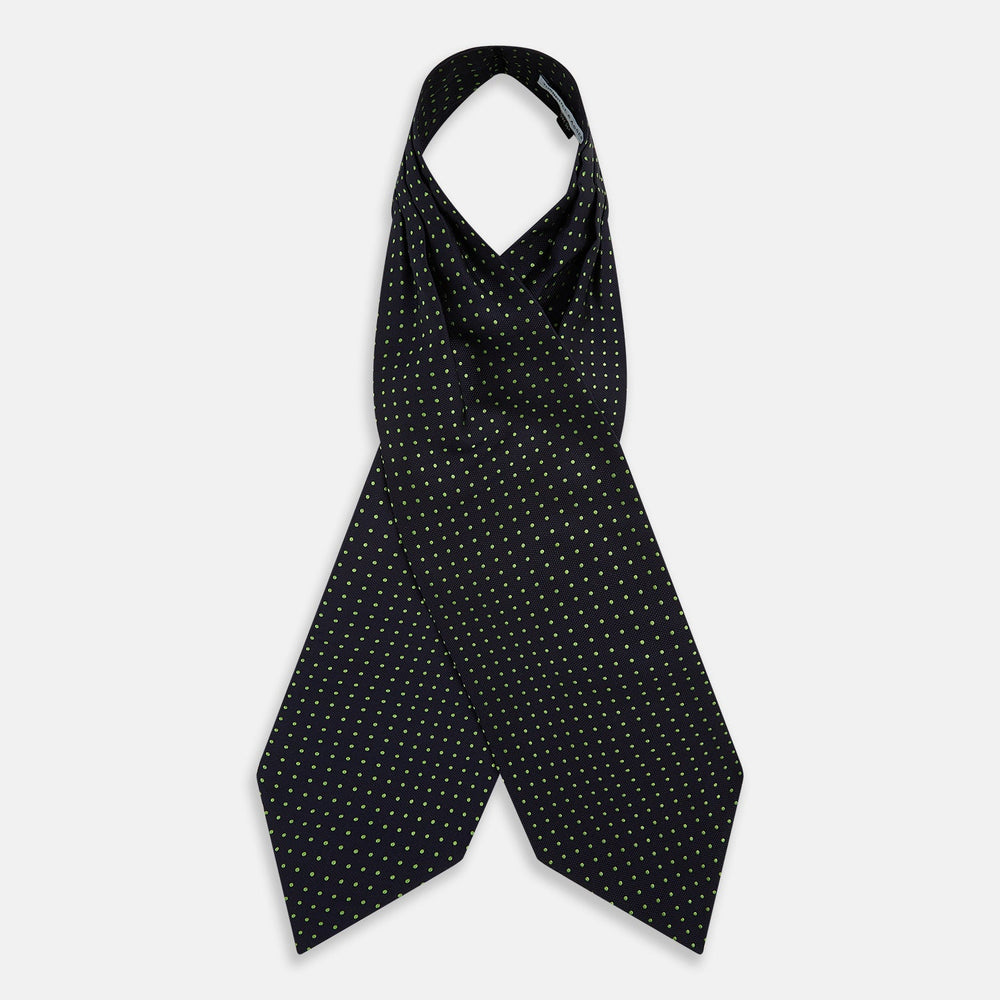 The Green Micro Dot and Navy Silk Cravat by Turnbull & Asser features fine green micro dots on navy silk, adding a refined touch to formalwear. Pair it with a matching pocket square for a cohesive, polished look.