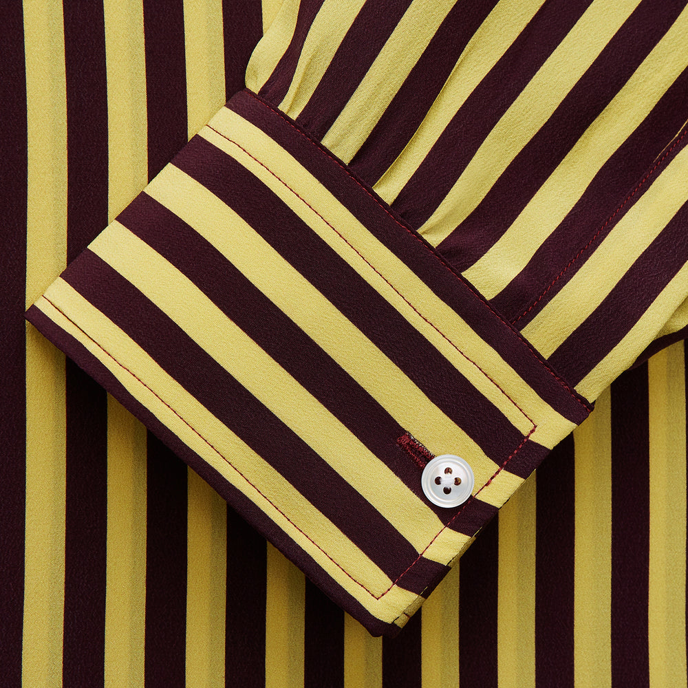 The Turnbull & Asser Yellow and Burgundy Candy Stripe Silk Weekend Fit Harold Shirt features long sleeves, a classic collar, white buttons, and a tailored design.