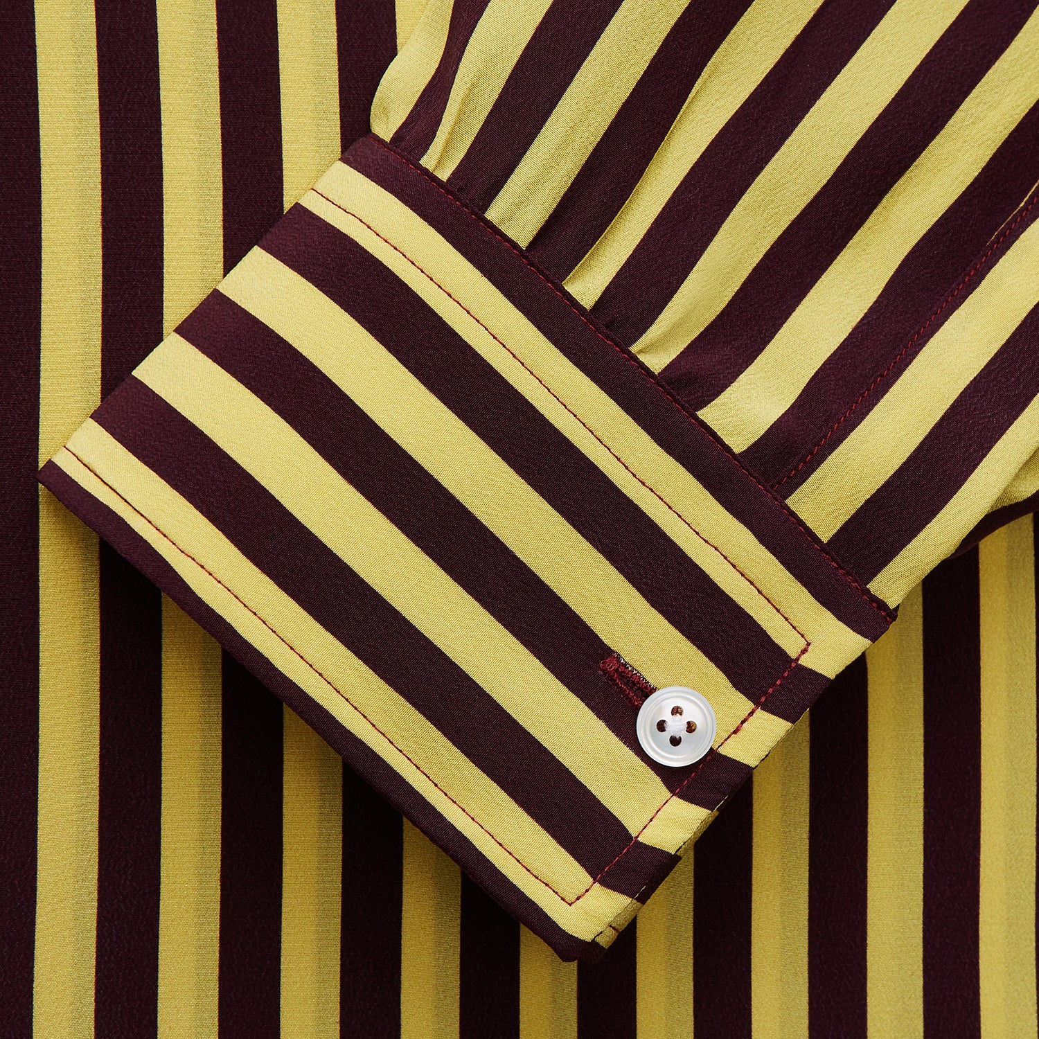 View 2 of product The Turnbull & Asser Yellow and Burgundy Candy Stripe Silk Weekend Fit Harold Shirt features long sleeves, a classic collar, white buttons, and a tailored design.