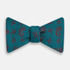 View 1 of product The Turnbull & Asser Teal Paisley Silk Bow Tie, featuring a red paisley and bee pattern, adds a touch of British elegance and formal refinement to your ensemble.