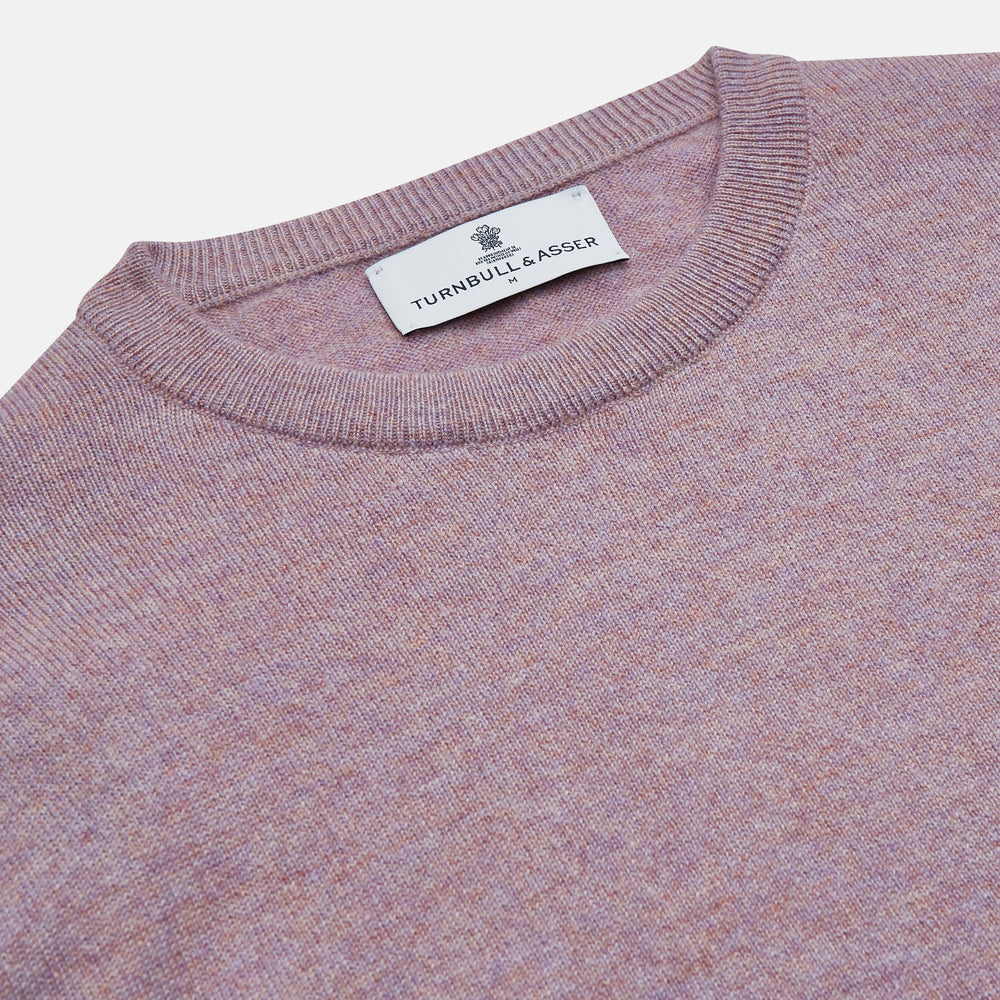The Turnbull & Asser Lilac Heather Glenn Cashmere Crew Neck Jumper, featuring long sleeves with ribbed cuffs and hem, is knitted in Scotland and shown laid flat on a white background.