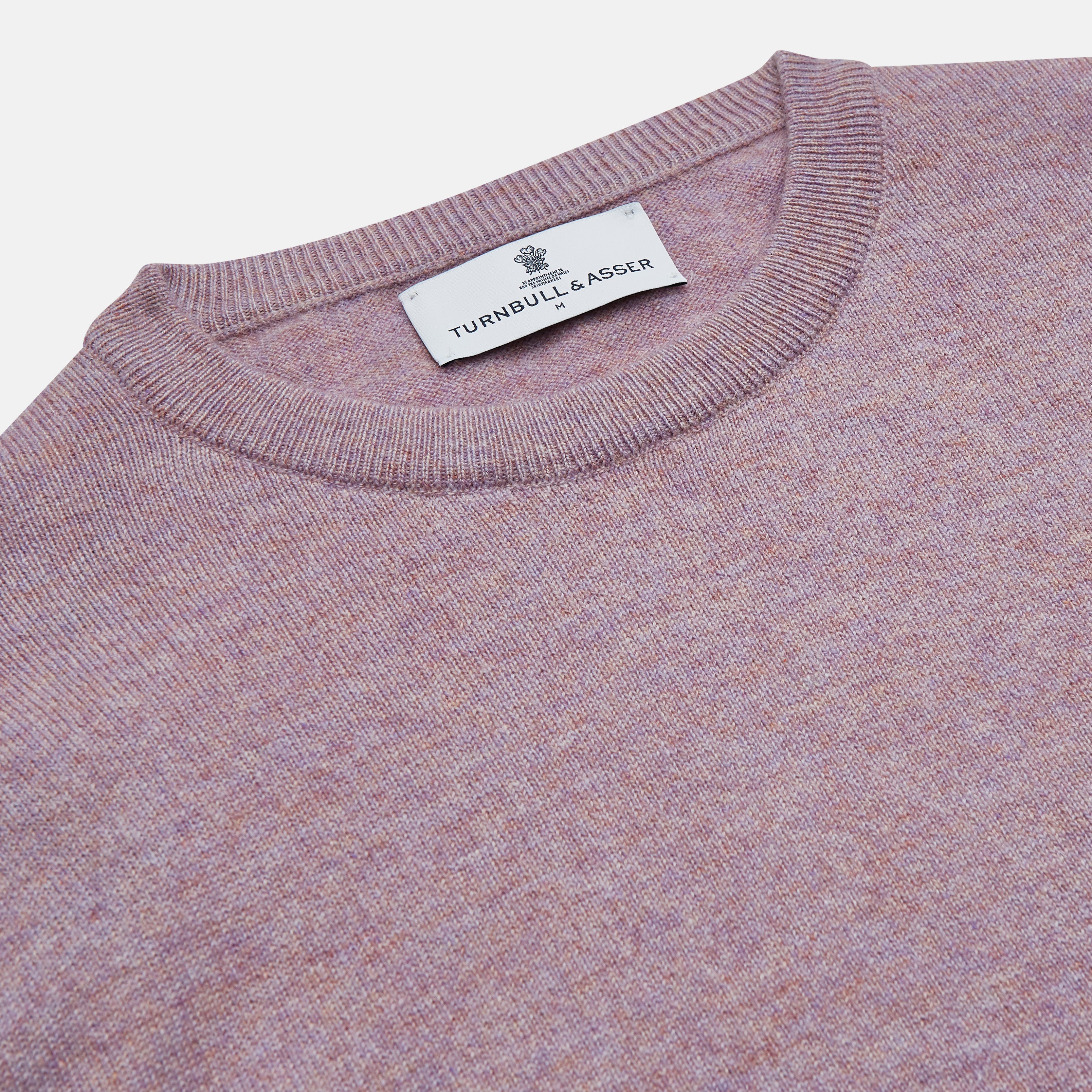 View 2 of product The Turnbull & Asser Lilac Heather Glenn Cashmere Crew Neck Jumper, featuring long sleeves with ribbed cuffs and hem, is knitted in Scotland and shown laid flat on a white background.