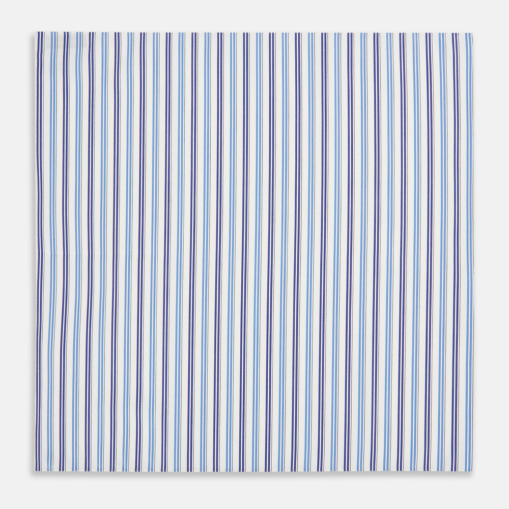 The Blue and Navy Multi Stripe Hand-Rolled Handkerchief by Turnbull & Asser is crafted in England with a white background and evenly spaced vertical stripes in blue and navy.