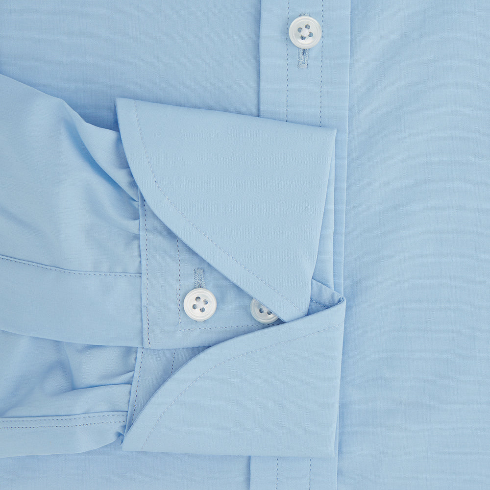 The Turnbull & Asser Dr. No Blue Cotton Shirt with a classic collar, cocktail cuffs, button-up front, and straight hem is featured on a plain white background. As seen on James Bond.