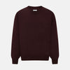 View 1 of product The Turnbull & Asser Burgundy Fine Merino V-Neck Jumper features a classic plain knit design with long sleeves, showcased against a crisp white background.