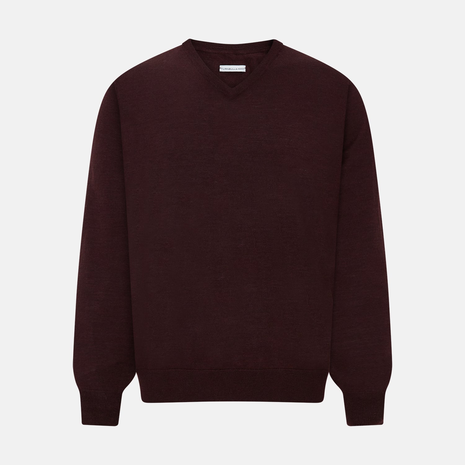 View 1 of product The Turnbull & Asser Burgundy Fine Merino V-Neck Jumper features a classic plain knit design with long sleeves, showcased against a crisp white background.