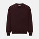 The Turnbull & Asser Burgundy Fine Merino V-Neck Jumper features a classic plain knit design with long sleeves, showcased against a crisp white background.