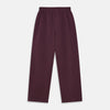 View 6 of product The Turnbull & Asser Plain Plum Silk Modern Pyjama Set, made in England, features white piping, a button-up long-sleeve top with three pockets, and matching pants. The pyjamas are shown against a white background.