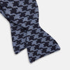 View 2 of product The Turnbull & Asser Navy and Blue Houndstooth Wool Blend Bow Tie features a self-tying design with a blue and black houndstooth pattern, showcased on a plain white background.