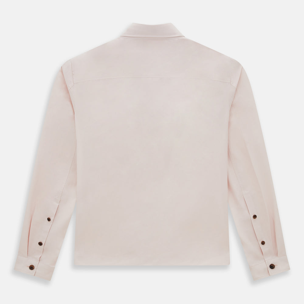 The Turnbull & Asser Pale Pink Hyde Overshirt is a long-sleeve, sanforised cotton button-up with a left chest pocket and dark buttons, shown laid flat on a white background.