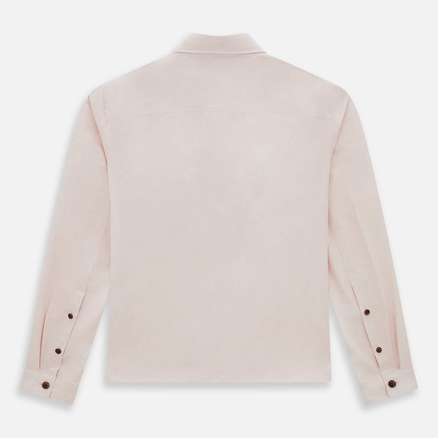 View 3 of product The Turnbull & Asser Pale Pink Hyde Overshirt is a long-sleeve, sanforised cotton button-up with a left chest pocket and dark buttons, shown laid flat on a white background.