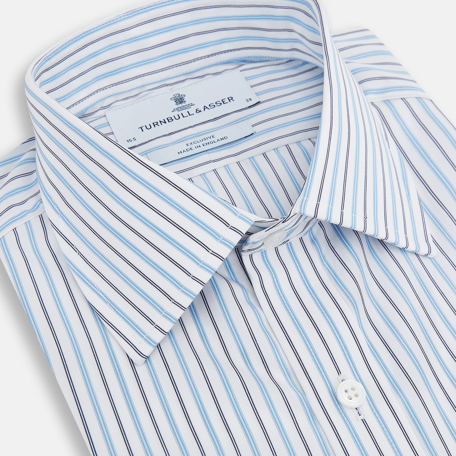 View 2 of product The Turnbull & Asser Blue Multi Halo Stripe Mayfair Shirt features long sleeves, a T&A collar with pointed tips, and buttoned cuffs, shown on a plain white background.