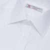 View 5 of product The Turnbull & Asser White Herringbone Superfine Cotton Shirt features a T&A collar, double cuffs, and a visible label inside the collar, shown neatly folded on a light blue background—ideal for minimalist looks or pairing with bold ties.