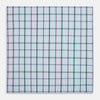 View 3 of product The Turnbull & Asser Hand Rolled Blue and Green Tattersall Check Handkerchief—a white cotton pocket square with blue, green, and black check pattern—is neatly displayed on a plain white background.