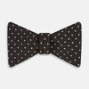 View 1 of product A stylish accessory, the White and Brown Micro Dot Silk Bow Tie by Turnbull & Asser features tiny brown dots on luxurious white silk, elegantly displayed against a plain white background.