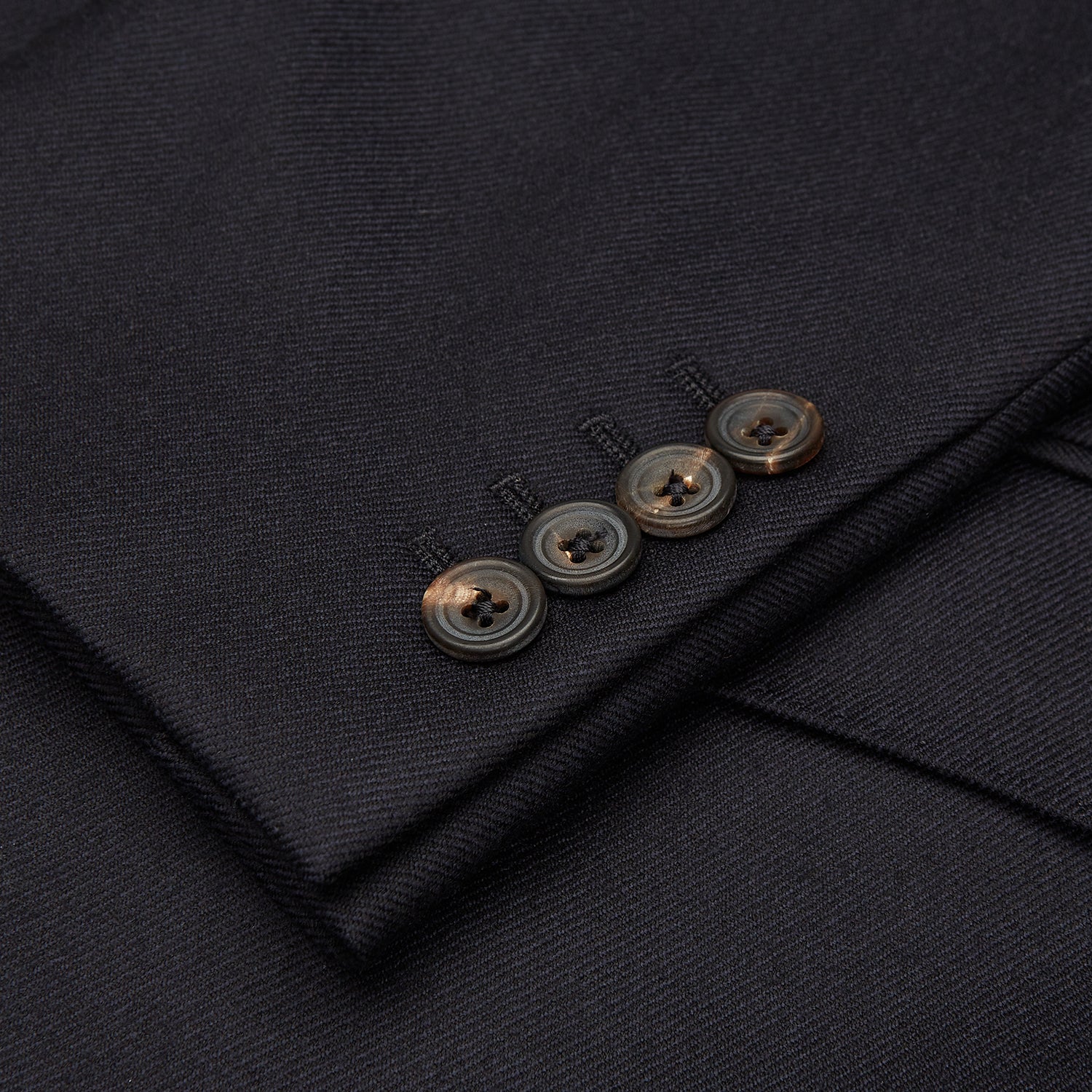 View 2 of product The Turnbull & Asser Navy Escorial Wool Jacket is a tailored men's blazer featuring notch lapels, a single-breasted one-button front, and multiple pockets, shown flat against a white background.