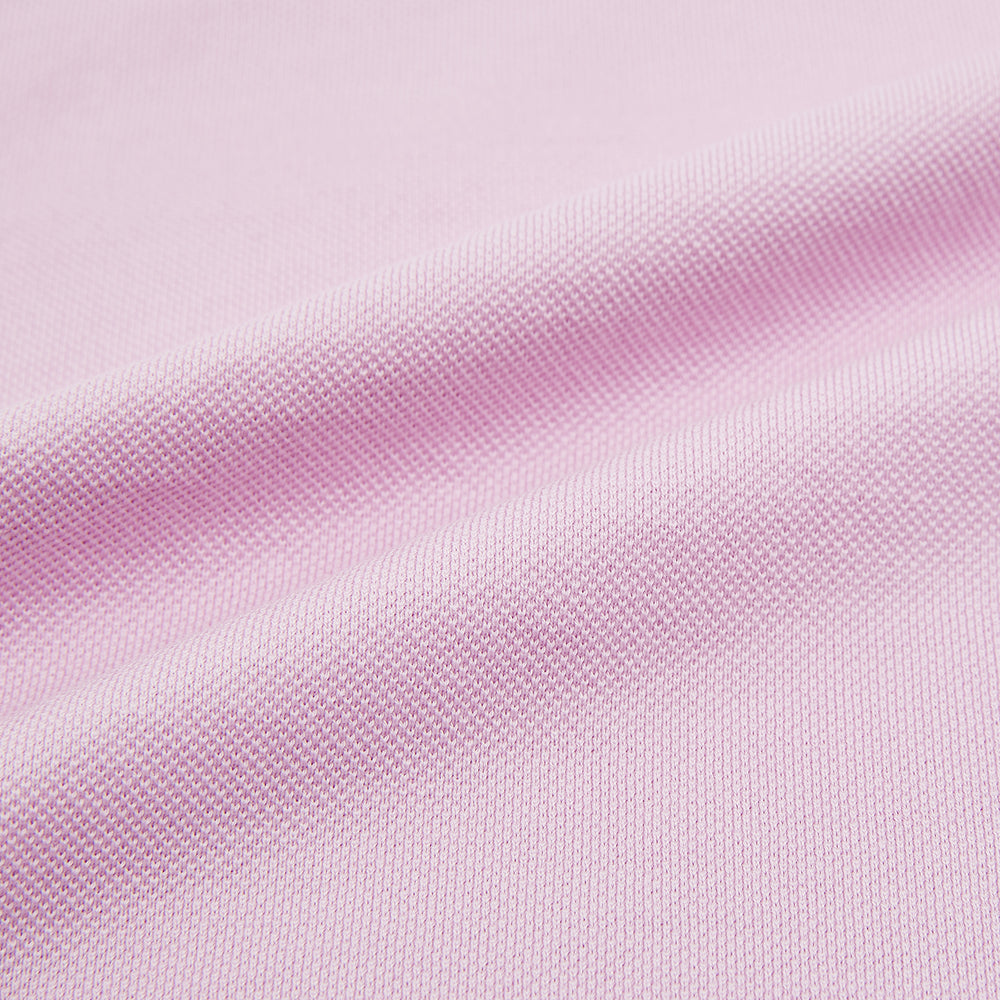 The Turnbull & Asser Pink Polo Shirt is a men's cotton polo with short sleeves, a collar, three dark buttons, and a chest pocket with a button, shown laid flat on a white background.