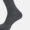 View 3 of product The Turnbull & Asser Steel Melange Mid-Length Sock, in dark gray ribbed mercerised Egyptian cotton, is shown upright on a white background to highlight its elegant shape and texture.