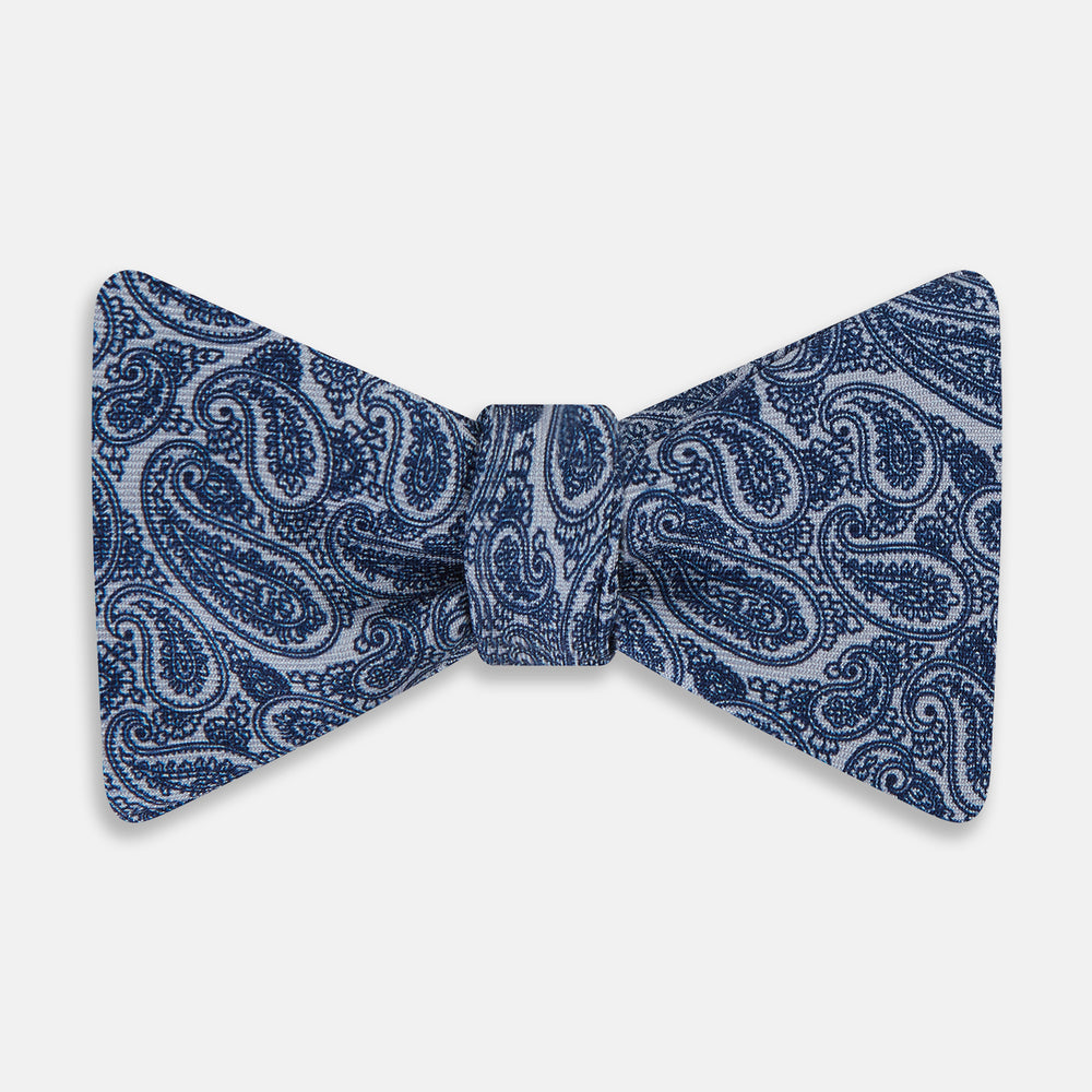 The Turnbull & Asser Pale Blue Paisley Silk Bow Tie, an elegant men's accessory, is showcased against a plain white background.