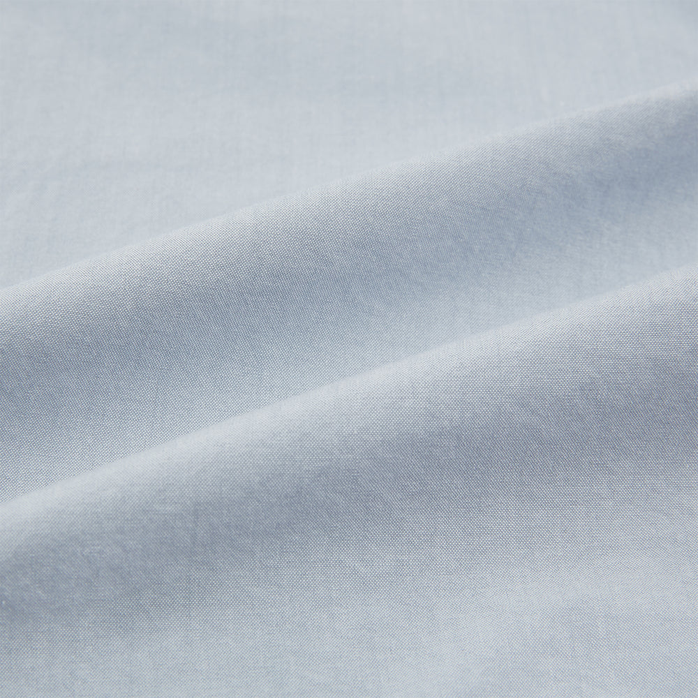 The Turnbull & Asser Grey Hyde Overshirt is a long-sleeve button-up made from sanforised cotton, featuring a single chest pocket and dark buttons, shown against a plain white background.