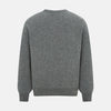View 3 of product The Turnbull & Asser Grey Melange Cashmere Round Neck Jumper for men features a classic crewneck design with ribbed cuffs, hem, and neckline, displayed against a white background.