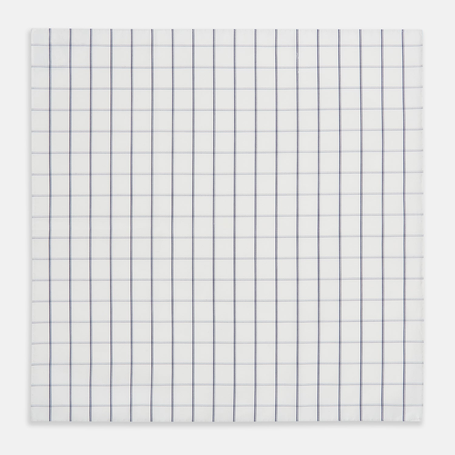 View 2 of product The Turnbull & Asser Dark Navy Double-Line Check Hand-Rolled Handkerchief features a white base with intersecting navy lines and hand-rolled edges, expertly crafted in England.