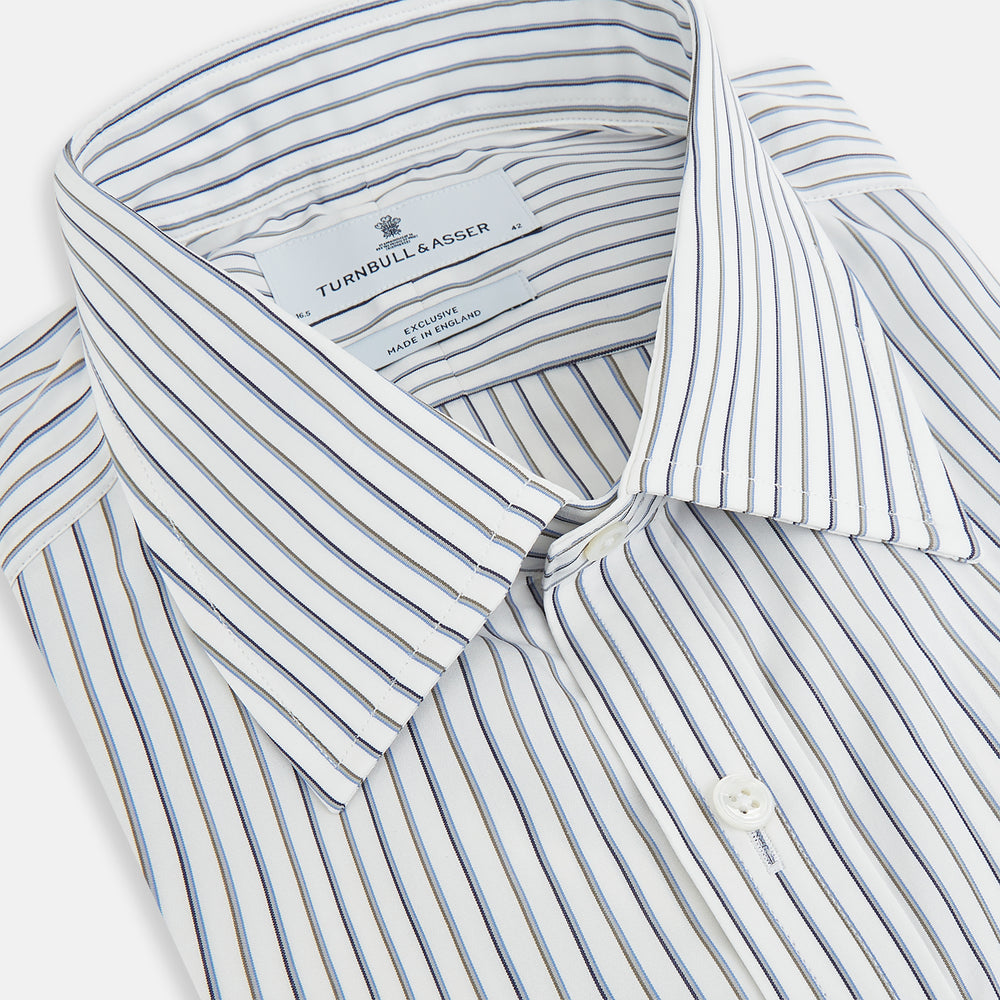 The Turnbull & Asser Brown and Blue Shadow Stripe Mayfair Shirt, featuring long sleeves, a pointed collar, and buttoned cuffs, is crafted from Italian fabric with vertical stripes and shown laid flat on a white background.