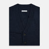 View 4 of product The Navy Melange Cashmere Cardigan by Turnbull & Asser features long sleeves, a V-neck, five dark buttons, ribbed cuffs and hem, and two front pockets. Shown against a plain white background.