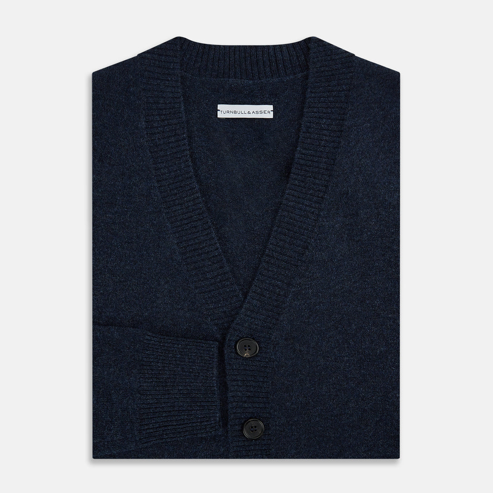 The Navy Melange Cashmere Cardigan by Turnbull & Asser features long sleeves, a V-neck, five dark buttons, ribbed cuffs and hem, and two front pockets. Shown against a plain white background.
