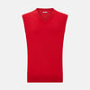 View 1 of product The Turnbull & Asser Red Cashmere V-Neck Vest features a sleeveless knit design and classic collar, shown against a white background—ideal for elevating any refined look.