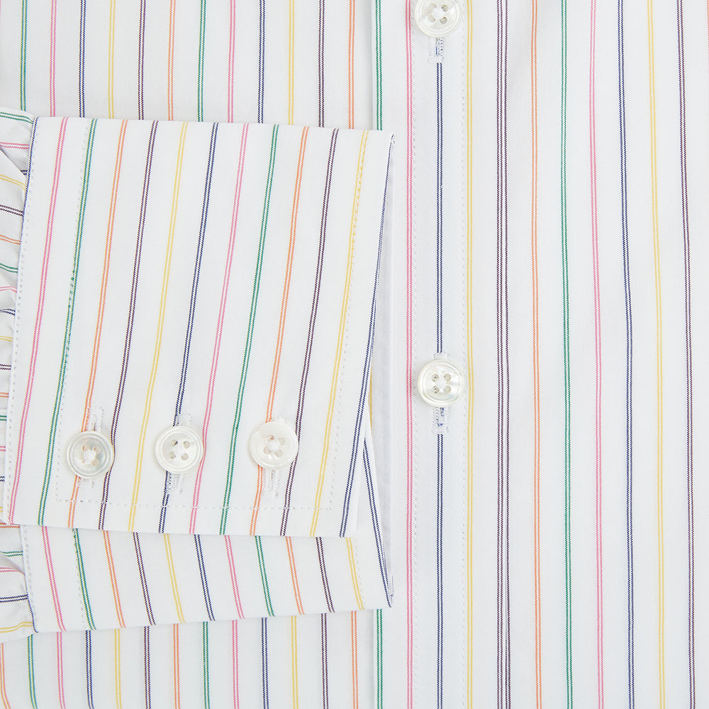 The Turnbull & Asser Rainbow Double Pinstripe Mayfair Shirt is a pure cotton, long-sleeved button-up with a collar and buttoned cuffs, featuring colourful blue, red, and yellow stripes on white, displayed on a plain white background.