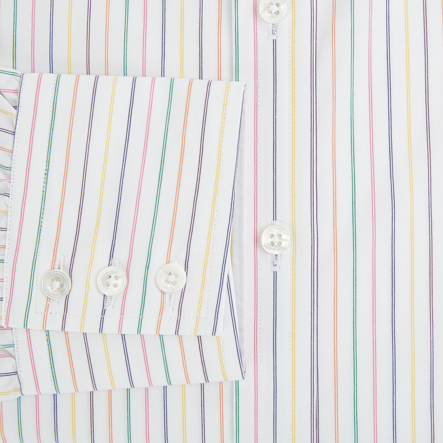 View 4 of product The Turnbull & Asser Rainbow Double Pinstripe Mayfair Shirt is a pure cotton, long-sleeved button-up with a collar and buttoned cuffs, featuring colourful blue, red, and yellow stripes on white, displayed on a plain white background.