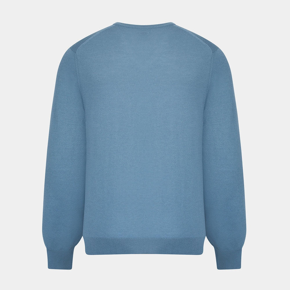 The Turnbull & Asser Pale Blue Fine Merino V-Neck Jumper features long sleeves, ribbed cuffs, and a straight hem. Shown against a white background, this classic knitwear combines comfort and style.