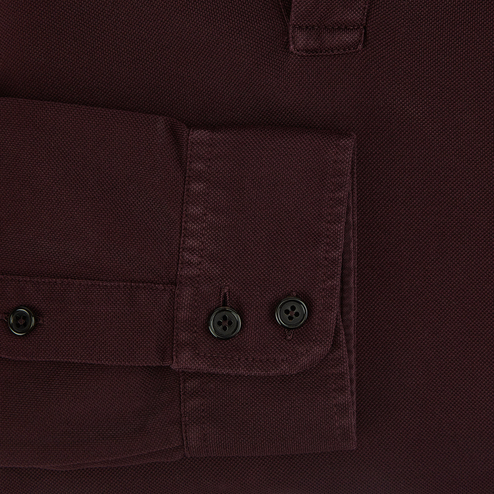 The Turnbull & Asser Burgundy Rugby Polo Shirt is a long-sleeve, pure cotton collared top with no visible buttons, shown laid flat on a white background.