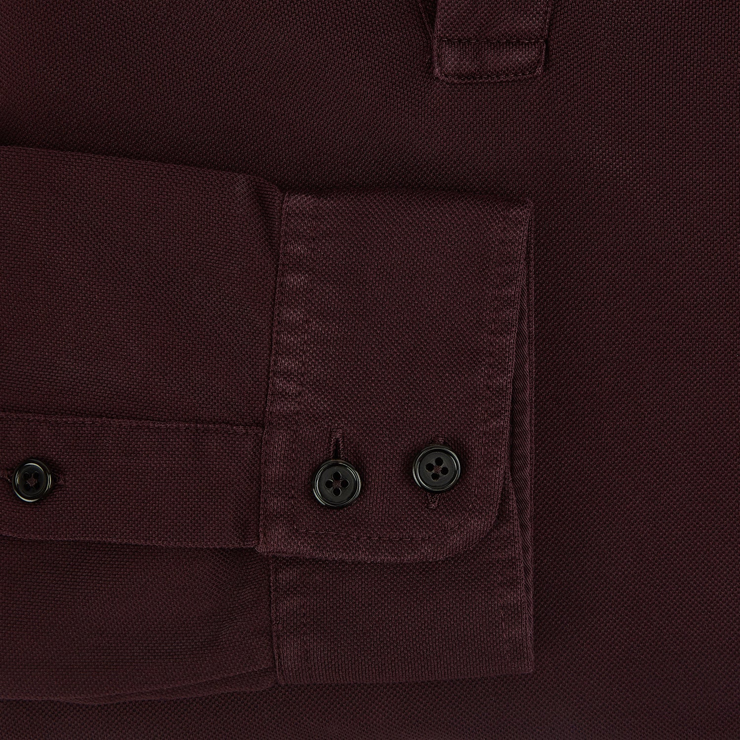 View 4 of product The Turnbull & Asser Burgundy Rugby Polo Shirt is a long-sleeve, pure cotton collared top with no visible buttons, shown laid flat on a white background.