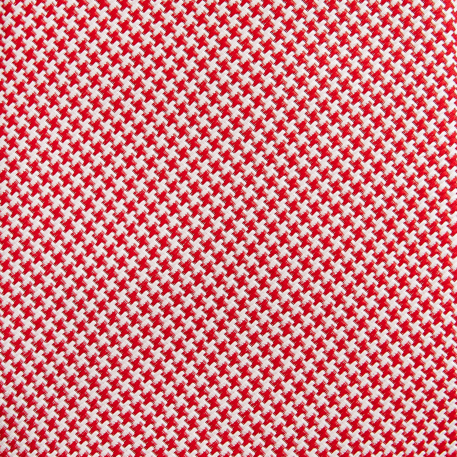 View 3 of product The Turnbull & Asser Red Houndstooth Silk Tie features a textured, small geometric pattern in red and white—ideal as a classic office accessory, shown rolled up on a plain white background.
