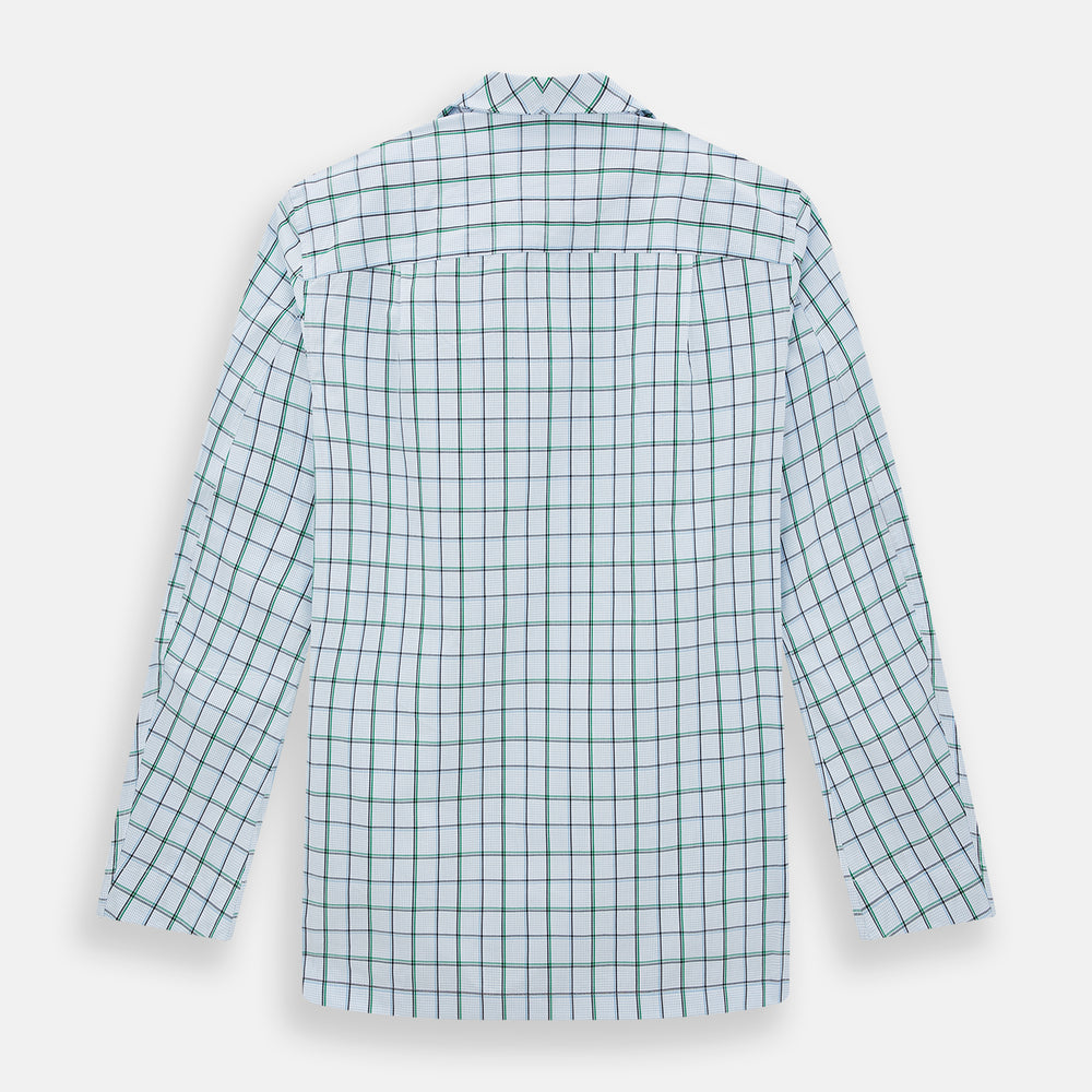The Turnbull & Asser Green and Blue Check Pyjama Shirt features long sleeves and a button-up design on a white base, offering elegant loungewear style. Shown laid flat against a white background.